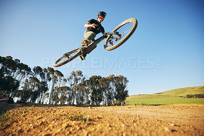 Buy stock photo Jump, mountain bike and man outdoor in nature for extreme sports, training or workout. Sky, air or wellness of male person with courage or bicycle stunt for off road cycling, travel or adventure
