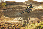 Dust, mountain bike and man outdoor in nature for extreme sports, training or workout. Downhill, fitness and male person with courage or bicycle stunt for off road cycling, travel or adventure