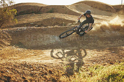 Buy stock photo Dust, mountain bike and man outdoor in nature for extreme sports, training or workout. Downhill, fitness and male person with courage or bicycle stunt for off road cycling, travel or adventure