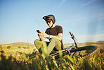 Phone, mountain bike and man outdoor in nature for extreme sports, training or workout. Smartphone, online communication and male person with bicycle for off road cycling, travel or adventure