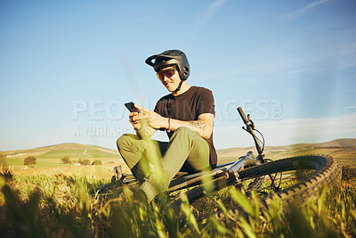 Buy stock photo Phone, mountain bike and man outdoor in nature for extreme sports, training or workout. Smartphone, online communication and male person with bicycle for off road cycling, travel or adventure