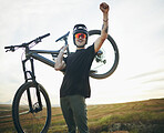 Mountain bike, man and celebrate success outdoor in nature for sports training or workout. Winner, fist and excited male person with bicycle for off road cycling, travel or adventure in countryside