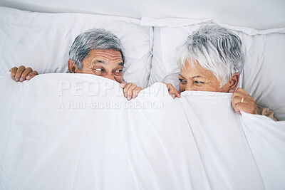 Buy stock photo Bed, funny and senior couple covering with a blanket in a bedroom bonding as happiness and playing to enjoy retirement. Happy, goofy and elderly people, man and woman with trust in marriage in a home
