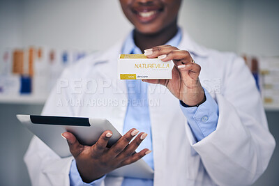 Buy stock photo Black woman, pharmacist and hands with tablet, medicine and skincare supplements in pharmacy, drugstore and healthcare. Medical professional, technology or doctor with pills for anesthesia in surgery