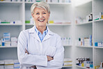 Portrait, senior pharmacist and woman with arms crossed in pharmacy, drugstore or shop for medicine. Smile, medical professional and face of doctor, healthcare expert and confident person from Canada