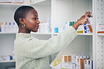 Black woman, customer and box on shelf for pills, medicine or medication at the pharmacy. African female person or patient shopping pharmaceutical product or drugs for healthcare cure at clinic store