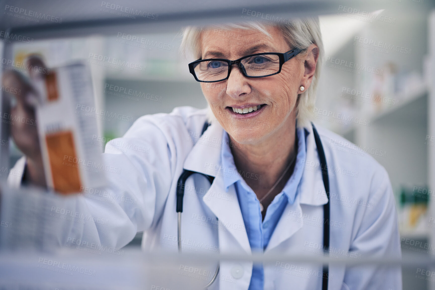 Buy stock photo Senior woman, pharmacist and reading medication on shelf for inventory, diagnosis or prescription at pharmacy. Happy mature female person, medical or healthcare professional checking medicine in shop