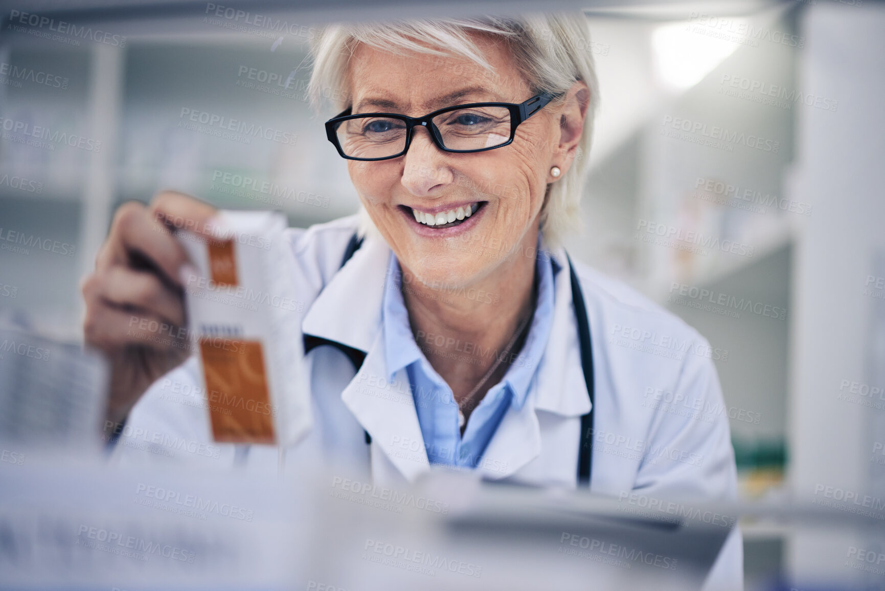 Buy stock photo Happy woman, pharmacist and reading medication on shelf for inventory, diagnosis or prescription at pharmacy. Mature female person, medical or healthcare professional checking medicine in drugstore