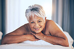 Happy senior woman, portrait and massage in relax for spa treatment, body care and physical therapy at resort. Calm elderly female person smile relaxing on salon bed for zen, stress relief or getaway