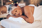 Senior woman, sleeping and relax in massage for spa treatment, body care and physical therapy at resort. Calm elderly female person smile and relaxing on salon bed for zen, stress relief or getaway