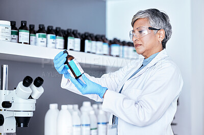 Buy stock photo Lab, science and woman checking bottle from shelf for medical research information and solution. Healthcare, medicine and innovation in manufacturing vaccine or chemical drugs with senior scientist.
