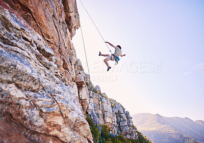 Buy stock photo Rock climbing, jump and mountains with man in nature for sports, explore and adventure. Space, exercise and travel with person training on cliff for rope, challenge and performance mockup
