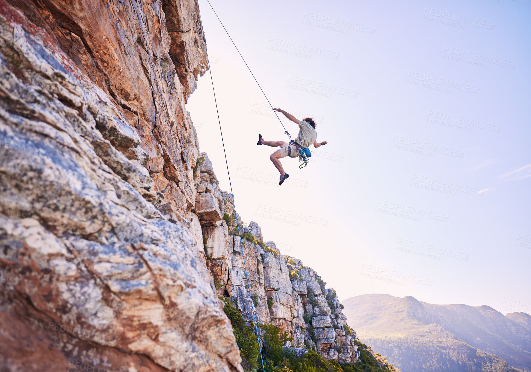 Buy stock photo Rock climbing, jump and mountains with man in nature for sports, explore and adventure. Space, exercise and travel with person training on cliff for rope, challenge and performance mockup