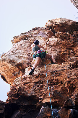 Buy stock photo Rock climbing, travel and mountains with woman in nature for sports, explore and adventure. Health, exercise and fitness with person training on cliff for rope, challenge and performance