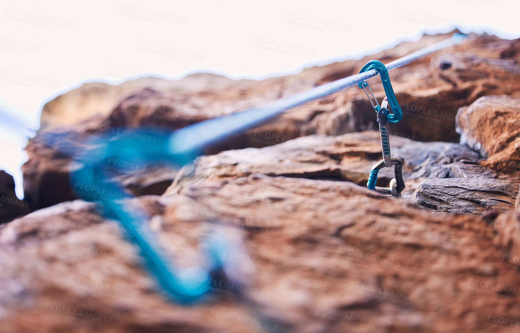 Buy stock photo Rock climbing, mountain and closeup of rope and hook for adventure, freedom and extreme sports in nature. Fitness, hiking and carabiner, equipment or gear in stone for training, activity or challenge