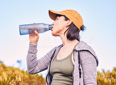 Buy stock photo Break, fitness and woman drinking water in nature for wellness, health and after training. Hydration, rest and an athlete with a bottle to drink after running, hiking or cardio on the mountain