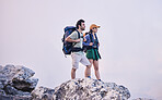 Mountains, hiking and man with woman on cliff for adventure in nature, landscape and travel. Outdoor trekking, couple on peak and relax in scenic clouds for natural journey, walking and rock climbing