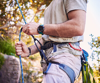 Buy stock photo Rock climbing, mountain and man with rope and harness for adventure, freedom and extreme sports in nature. Fitness, hiking and male person with equipment or gear for training, activity and challenge