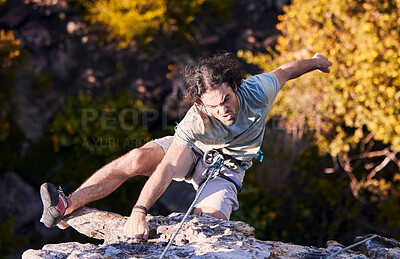 Buy stock photo Adventure, grab and sports, man rock climbing on mountain with cable for support and safety. Extreme workout, challenge and courage, climber on cliff with rope, commitment and fitness in nature.