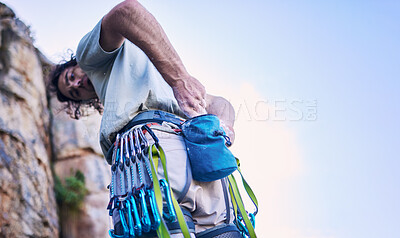 Buy stock photo Rock climbing, mountain and man with chalk and harness for adventure, freedom and extreme sports in nature. Fitness, hiking and male person with gear and powder for training, activity and challenge