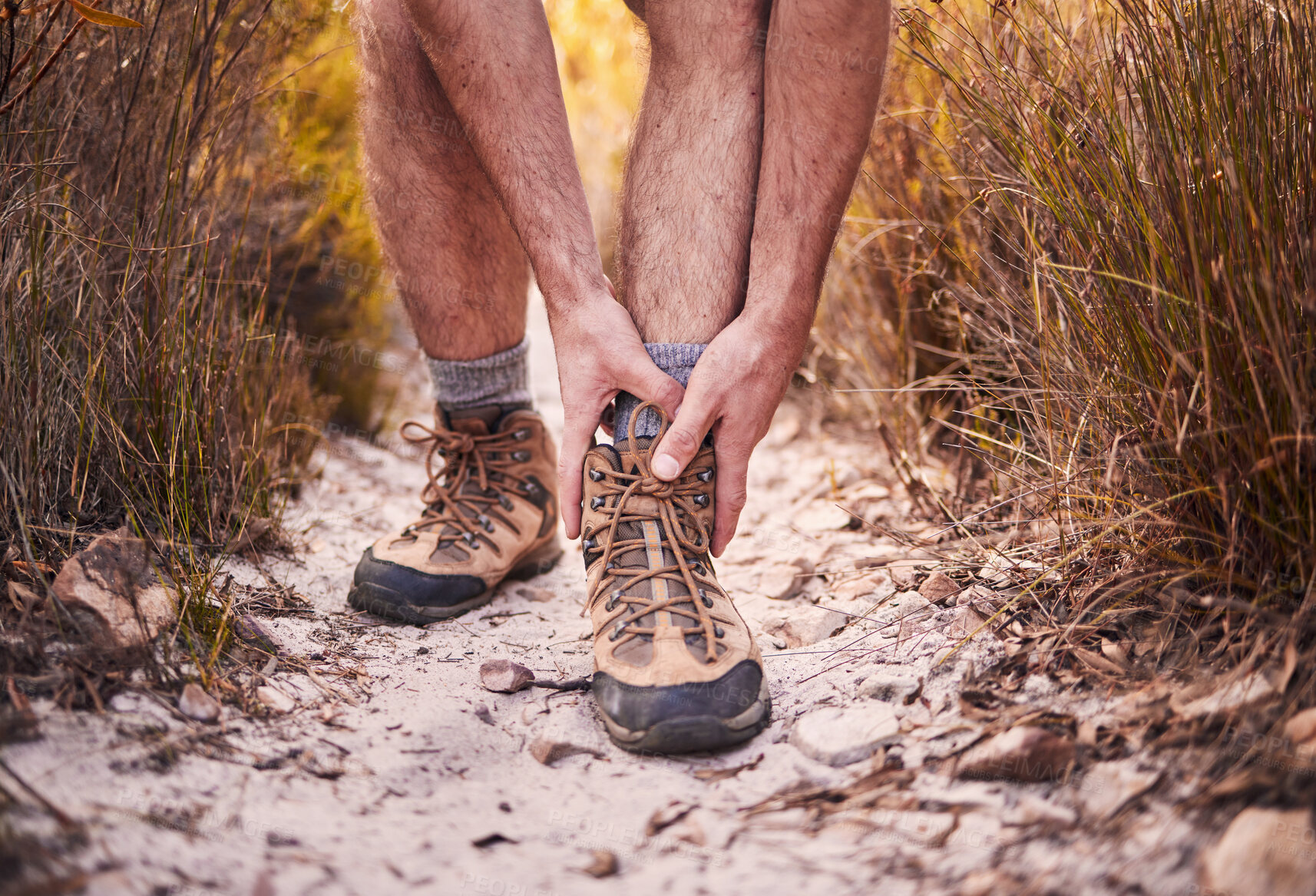 Buy stock photo Hiking, injury and shoes of man in nature for leg pain, training and accident. Emergency, healthcare and inflammation with closeup of person walking on path for muscle, trekking and problem