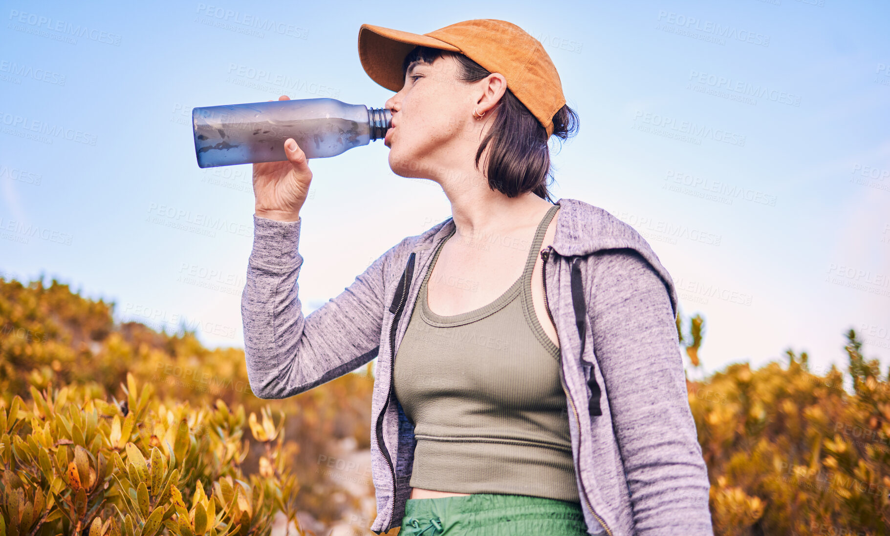 Buy stock photo Thinking, hiking and woman drinking water in nature for wellness, health and after training. Hydration, idea and an athlete with a bottle to drink after running, workout or cardio on the mountain