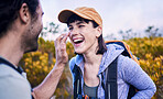 Hiking, sunscreen and happy couple on mountain for adventure, holiday and journey in nature. Travel, dating and man and woman laughing with spf cream to explore, trekking and backpacking outdoors