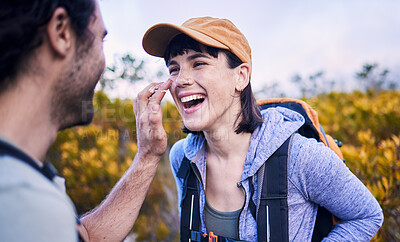 Buy stock photo Hiking, sunscreen and happy couple on mountain for adventure, holiday and journey in nature. Travel, dating and man and woman laughing with spf cream to explore, trekking and backpacking outdoors