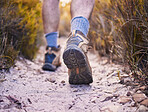Hiking, fitness and shoes of man in nature for relax, explore and trekking adventure. Travel, workout and exercise with closeup of person walking on forest path for training, sports and health