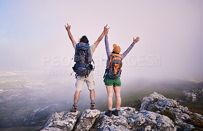 Buy stock photo Mountain, hiking achievement and couple from back on adventure in nature, landscape and travel. Outdoor trekking, man with woman on cliff and relax in view of clouds, natural journey and winning.