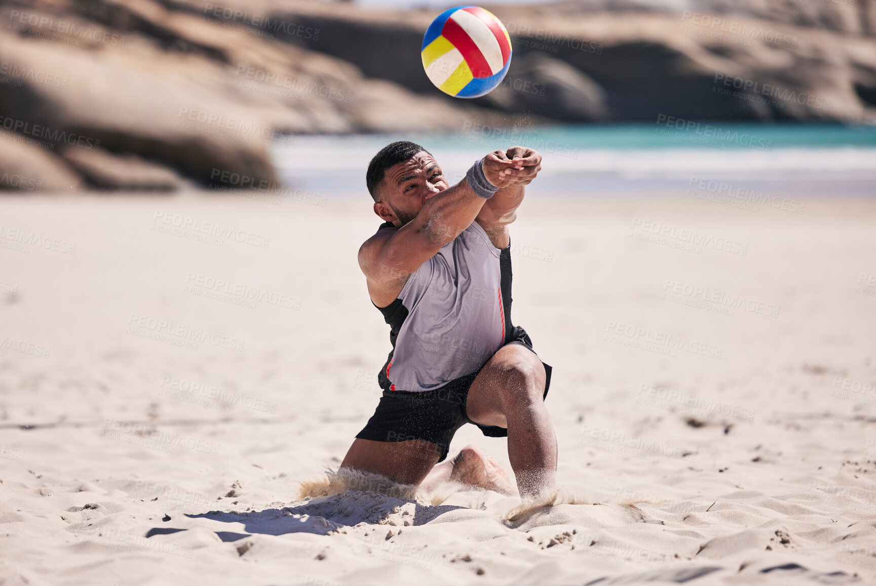 Buy stock photo Beach, volleyball and athlete in action for a match while jumping on the sand on tropical weekend trip. Fitness, sports and young man training or playing a seaside game or tournament by the ocean.