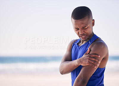 Buy stock photo Sports, arm pain and man at a beach for exercise, fitness and training with problem. Shoulder, injury and African person with arthritis, fibromyalgia or osteoporosis during workout on mockup space