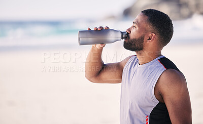 Buy stock photo Beach, fitness and man drinking water after running, workout or cardio exercise on mockup space. Hydration, drink and thirsty male runner with bottle at the sea for training, wellness or sports