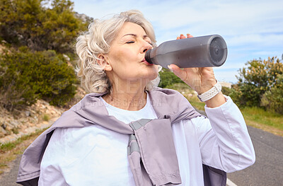 Buy stock photo Elderly woman, drinking water and bottle on road for fitness, running or thinking for vision, hydration or health. Mature lady, runner and detox with relax for wellness, exercise or workout in nature