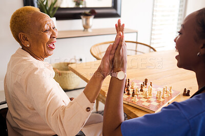 Buy stock photo Black people, nurse and high five in elderly care for chess, fun or social activity or game together at home. African medical professional touching hands with senior female person with a disability