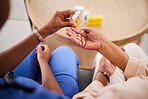 Woman, hands and nurse with pills for patient in elderly care, support or trust at old age home. Closeup of female person, medical or healthcare caregiver giving medication to senior for cure or dose