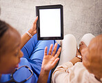 Nurse, caregiver and tablet mockup with patient above for consultation or healthcare advice at the home. Hands of doctor in elderly care consulting senior female person on technology display in house