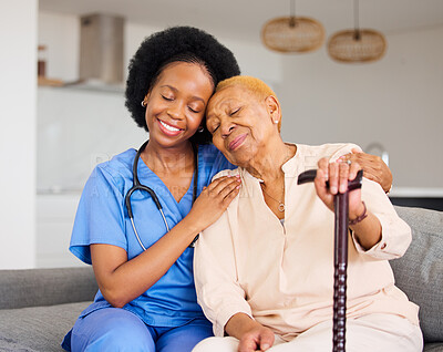 Buy stock photo Black woman, nurse and senior patient in elderly care, hug and healthcare on living room sofa at home. Happy African medical professional or caregiver help person with kindness and cane in house