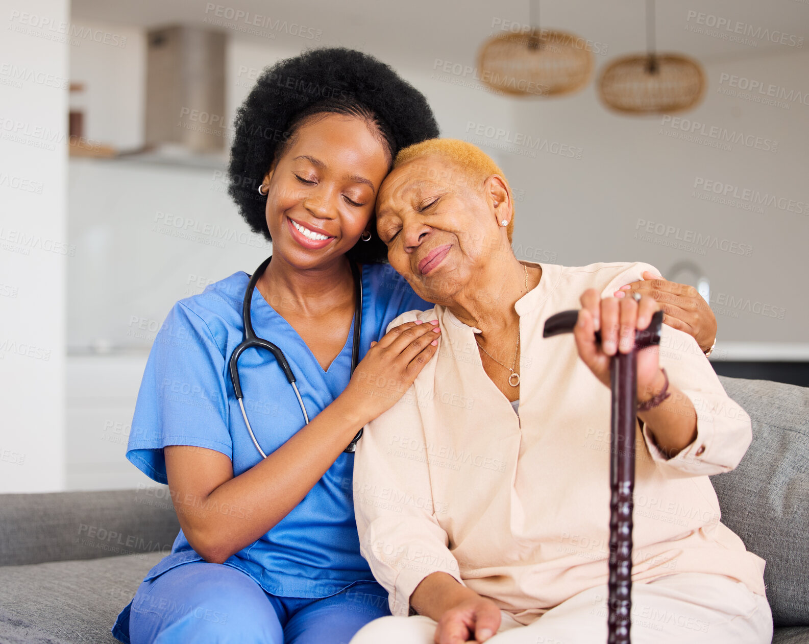 Buy stock photo Black woman, nurse and senior patient in elderly care, hug and healthcare on living room sofa at home. Happy African medical professional or caregiver help person with kindness and cane in house