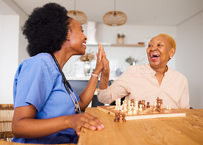 Buy stock photo Caregiver playing chess with an elderly patient after healthcare consultation in nursing rehabilitation center. Board game, high five and female nurse bonding with senior woman in retirement home.
