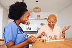 Nurse playing chess with a mature woman after a healthcare consultation in nursing rehabilitation center. Board game, conversation and female caregiver bonding with elderly patient in retirement home