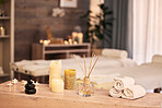 Spa room, candles and hotel background for massage, aromatherapy and self care holiday or vacation. Bokeh, interior and skincare salon with table, furniture and healing tools or fragrance product