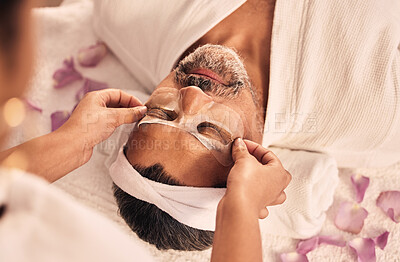 Buy stock photo Wellness, eye mask and mature man at a spa for health, self care and zen treatment. Relax, calm and masseuse hands doing a beauty facial massage routine on a senior male person at luxury peace salon.