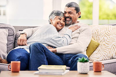 Buy stock photo Happy, hug and senior couple relax on a sofa with love, bond and laugh with conversation. Old people, living room and embracing with smile, trust and soulmate connection while enjoying retirement 