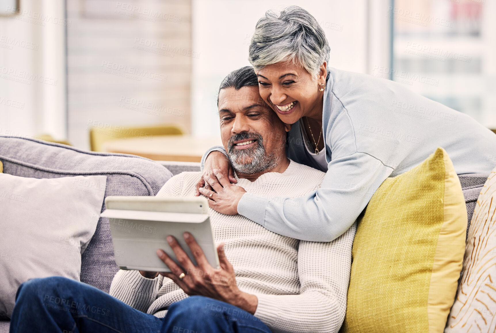 Buy stock photo Tablet, video call and senior couple embracing while networking on social media or mobile app. Happy, communication and mature man and woman on a virtual conversation on digital technology at home.