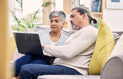 Buy stock photo Planning, laptop and senior couple on a sofa for streaming, sign up or subscription discussion in their home. Retirement, relax and old people online in a living room for internet, movie or search 