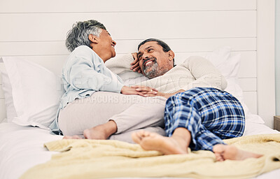 Buy stock photo Talking, funny or old couple in bedroom to relax, enjoy romance or morning time together at home. Holding hands, senior woman or happy elderly man laughing or bonding with love, support or smile 