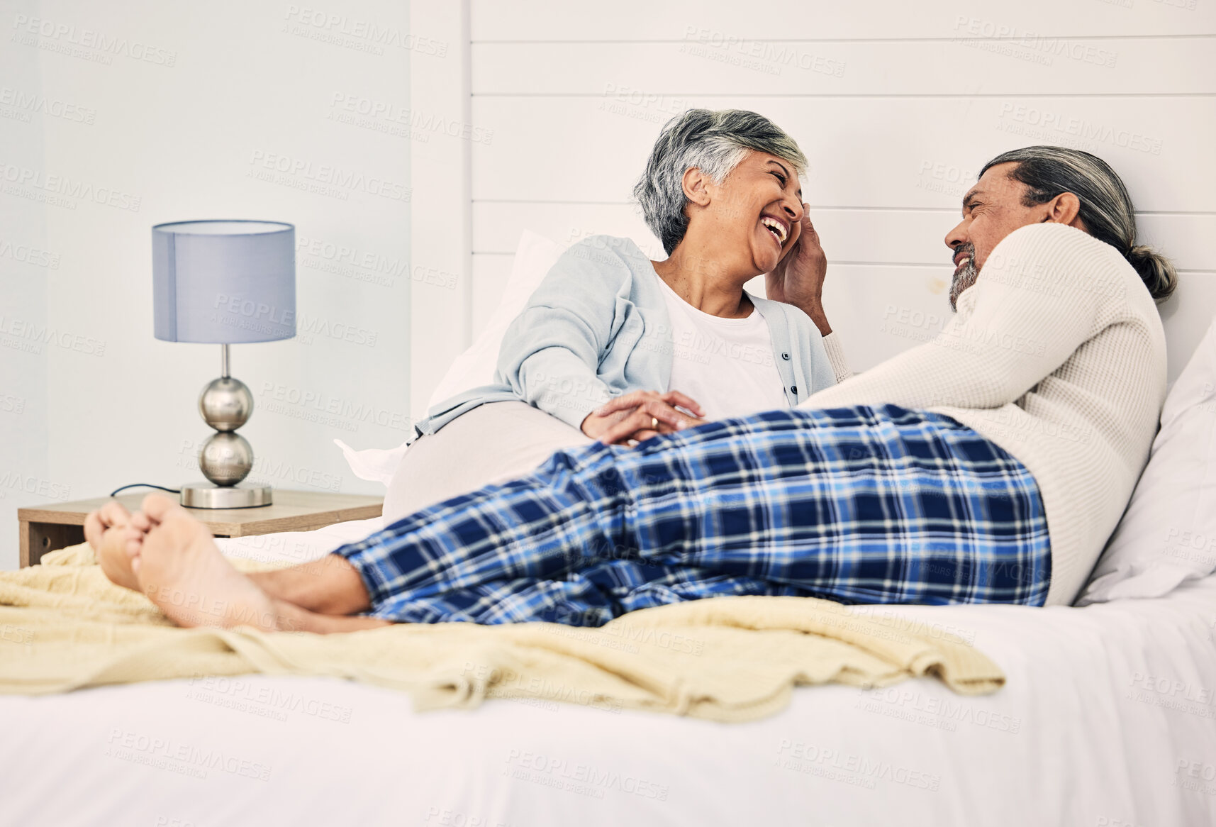 Buy stock photo Love, relax and an old couple in bed together, bonding in the morning while enjoying retirement in their home. Happy, conversation and a senior man with his wife in the bedroom while on holiday