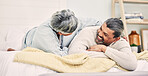 Lying, funny or old couple in bedroom to relax, enjoy romance or morning time together at home. Hugging, silly senior woman or happy elderly man laughing or bonding with love or smile in retirement