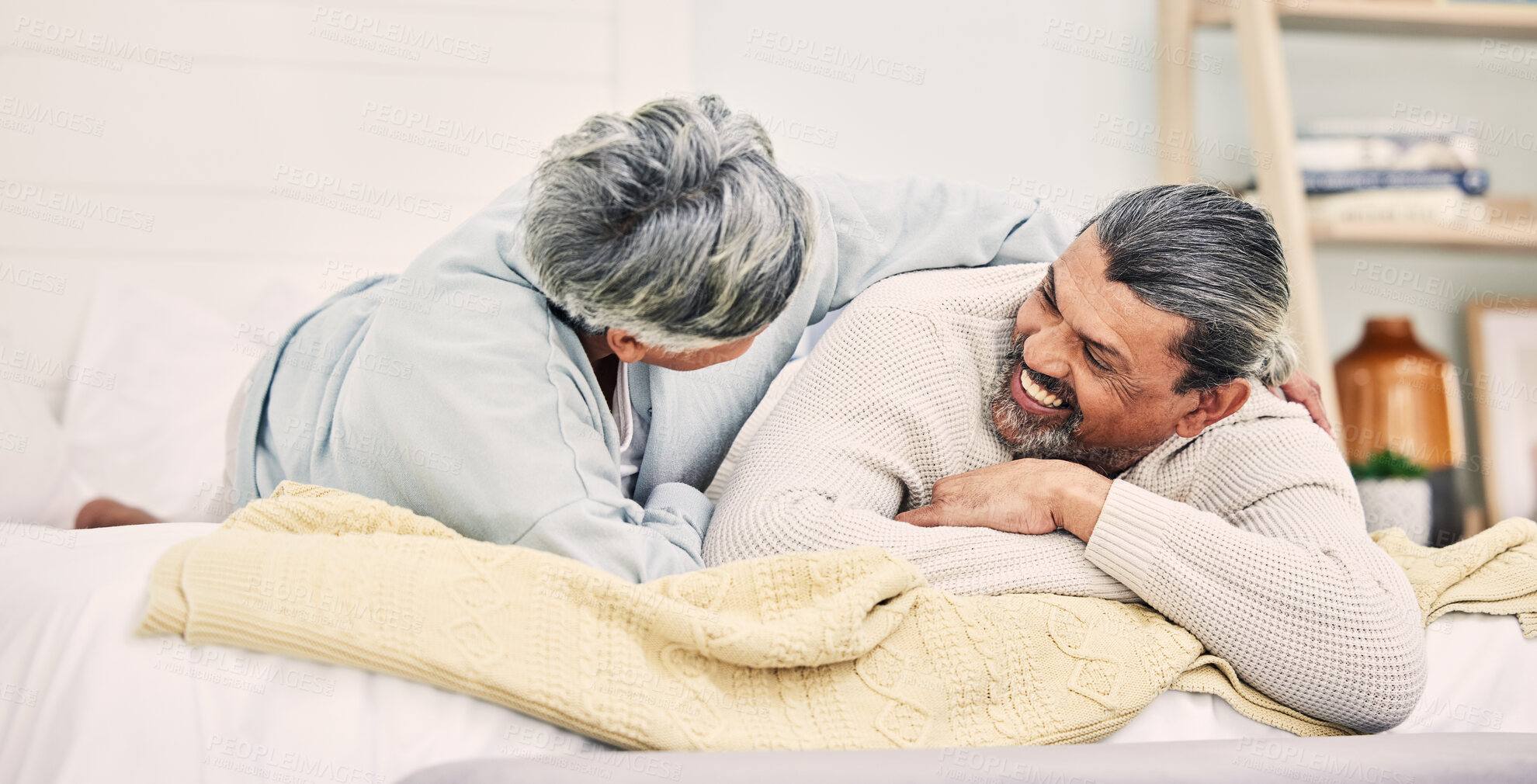 Buy stock photo Lying, funny or old couple in bedroom to relax, enjoy romance or morning time together at home. Hugging, silly senior woman or happy elderly man laughing or bonding with love or smile in retirement